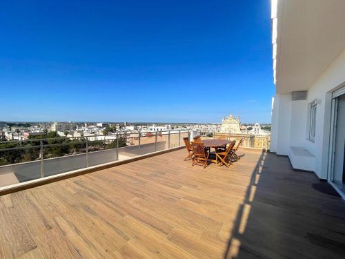 a balcony with a table and chairs on a building at Rooftop Galatina in Galatina