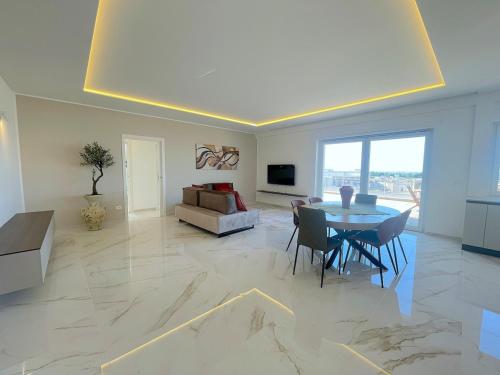 a living room with a table and a couch at Rooftop Galatina in Galatina