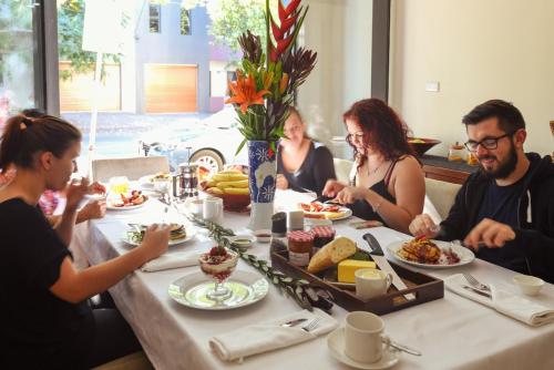 a group of people sitting around a table eating food at Lily Sands Inn in Melbourne