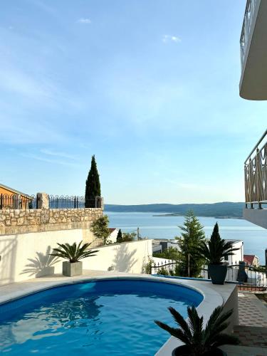 a swimming pool in a villa with a view of the water at Apartment Delic in Crikvenica