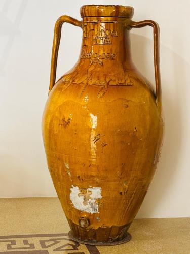 a large orange vase sitting on a table at Le Terrazze di Vico Moline in Nardò