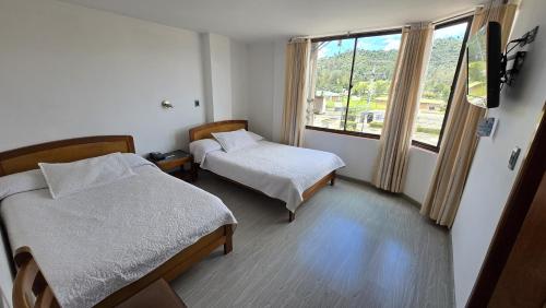 a hospital room with two beds and a window at Hotel Imperial in Chiquinquirá