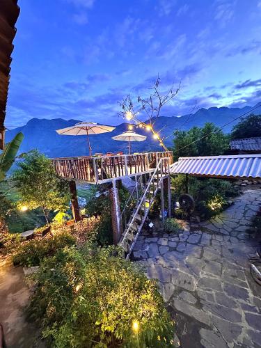 a deck with two umbrellas and a ladder at Surelee Homestay in Sa Pa