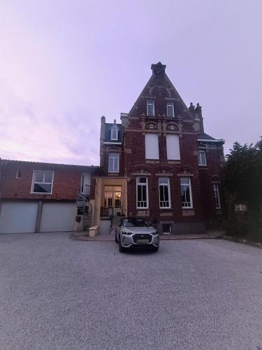 une voiture garée devant une grande maison en briques dans l'établissement jacuzzi, massage table, relaxation, wedding, loveroom, à Wizernes