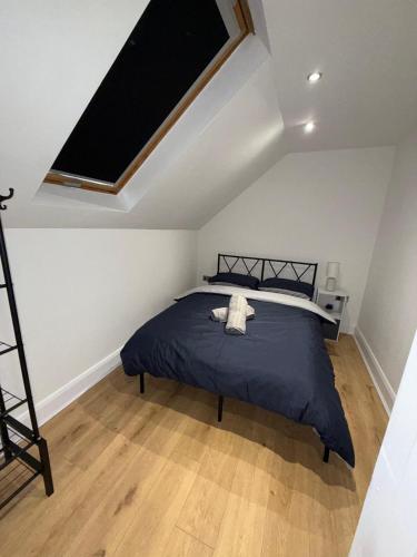 a bedroom with a bed and a skylight at Cosy 2 Bed Cardiff Bay Retreat! in Cardiff