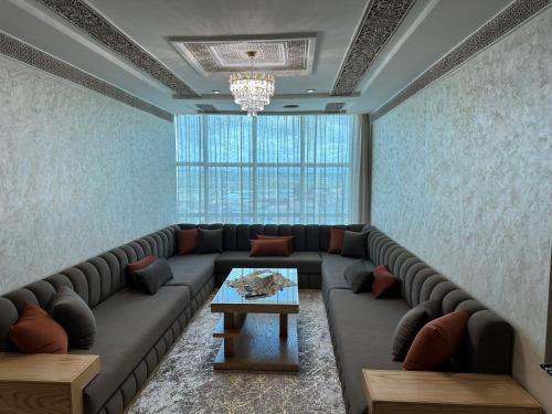 a living room with a large couch and a table at Ibtissam luxury residence in Larache