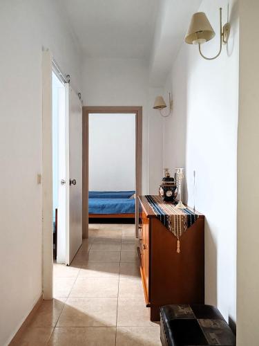 a room with a hallway with a bed and a table at Konstantina's cottage Ideal BaseforBalos & Elafonisi in Kissamos
