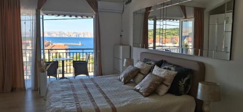 a bedroom with a bed with a view of the ocean at Beautiful sea view 6 luxury studio Danijela in Senj