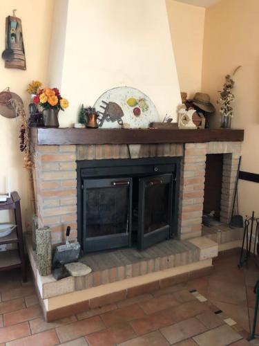 a living room with a brick fireplace at Camera Friuli in Nettuno