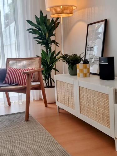 a living room with a chair and a mirror at Barra B Suite Apartment - 4min walk from BEACH, Terrace in Praia da Barra