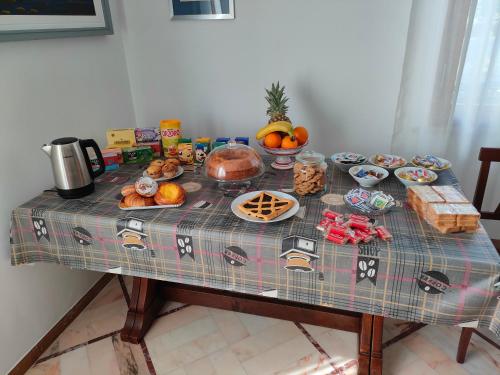 a table with a plaid table cloth with food on it at Villa Luciana in Fano