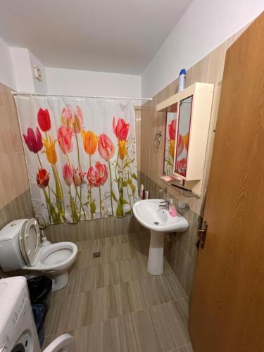 a bathroom with a toilet and a sink at Majki Beach Apartments in Sarandë