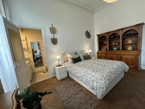 une chambre avec un lit, une commode et un miroir dans l'établissement Les Floralies Chapitre Canebière, à Marseille