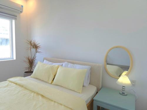 a bedroom with a bed with a mirror and a table at An Home - Phòng đơn ngay bãi sau Vũng Tàu in Vung Tau