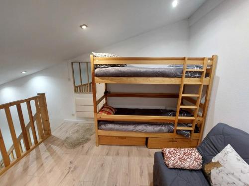 a room with two bunk beds and a couch at Cocooning Family Duplex La Foux d'allos in Allos