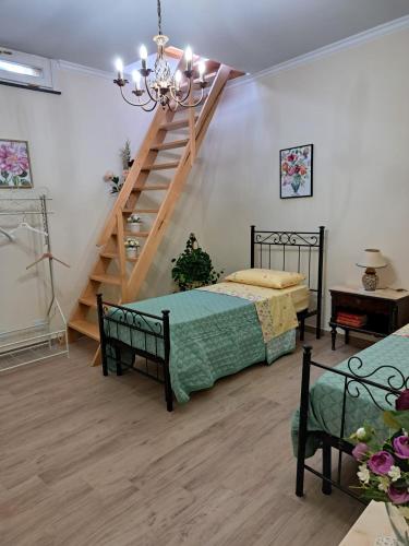 a room with two beds and a staircase in it at Casa Parrinello Maletto Etna in Maletto