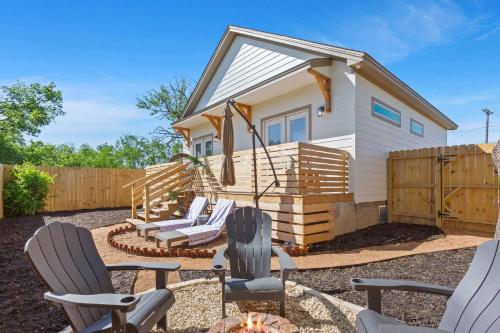a tiny house with a deck and two chairs at Stay in Luxury near Baylor University & Downtown in Waco