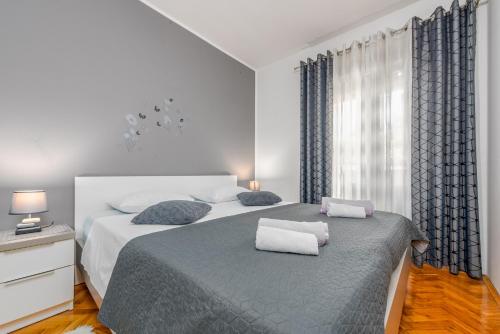 a bedroom with a bed with two pillows on it at Floyd in Bibinje