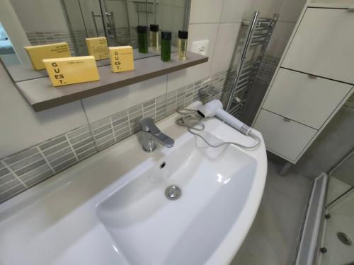 a white sink in a bathroom with a mirror at Villa Luciana in Fano