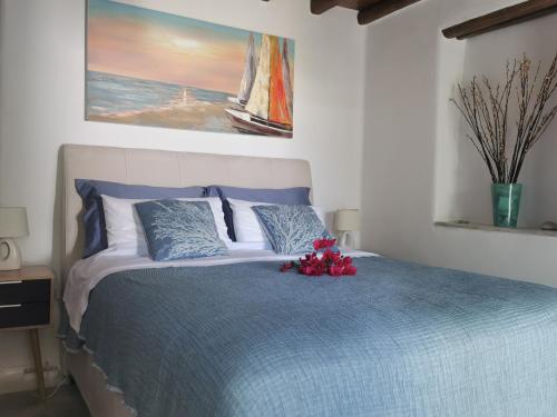 a bedroom with a bed with red flowers on it at Our Beautiful House in Ornos, Mykonos in Ornos