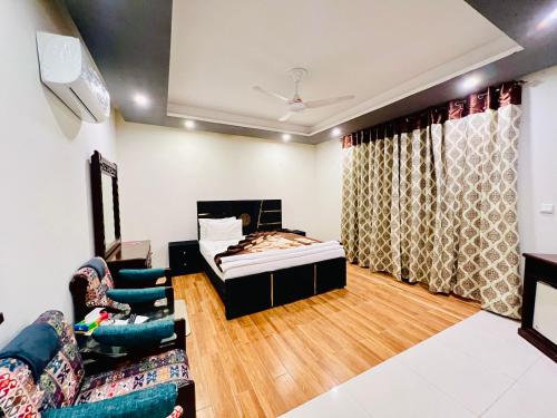 a living room with a bed and a couch at Family Luxury Lodges in Islamabad