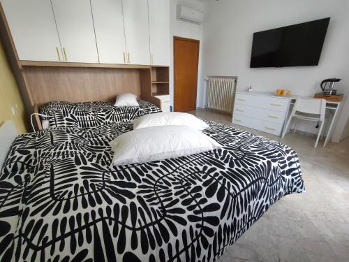a bedroom with a black and white bed with pillows at Villa Luciana in Fano