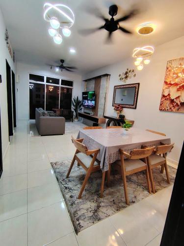 a living room with a table and a couch at Homestay Naaila, Alor Gajah in Kampong Jelatang