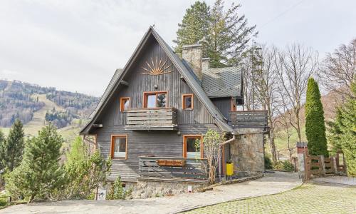 a house with a gambrel roof on a mountain at Willa Widok in Szczyrk