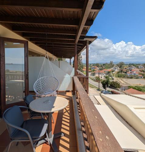 a balcony with a table and chairs and a view at Althea Apartments in Katakolon