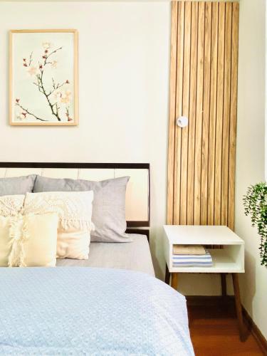 a bedroom with a bed with a nightstand next to it at Aydınoğlu Suites in Denizli