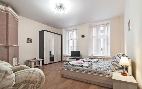 a bedroom with two beds and a mirror at Apartments near Mariinsky Theatre in Saint Petersburg