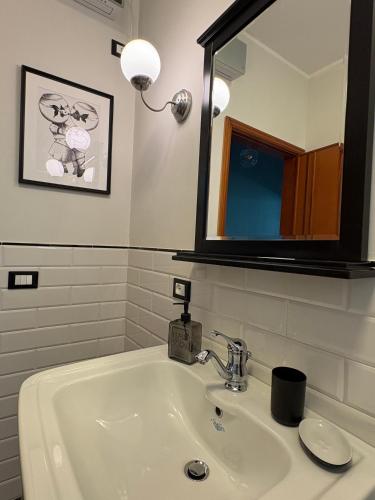 a bathroom with a sink and a mirror at Nest - Family House in Santa Flavia