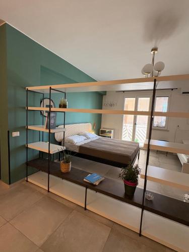a room with two bunk beds and a green wall at Nest - Family House in Santa Flavia