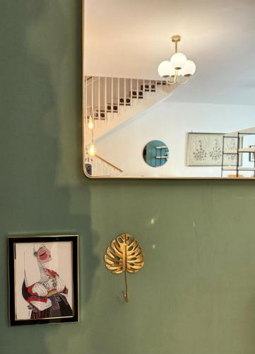 a room with a staircase and a fan on the wall at Nest - Family House in Santa Flavia