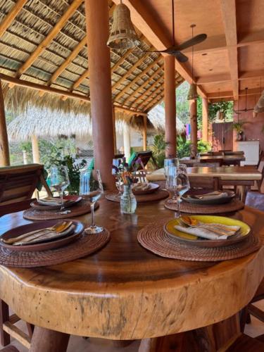 a wooden table with plates of food on top of it at La Alberca Hotel Boutique in Mazunte