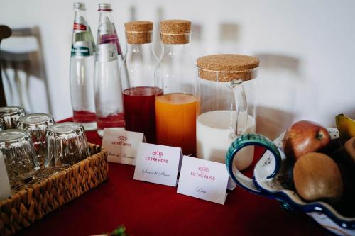 a table with bottles of juice and a bowl of bread at Tenuta Le Tre Rose in Vibonati