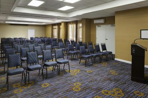 a large room with chairs and a podium in it at Courtyard by Marriott Riverside UCR/Moreno Valley Area in Riverside