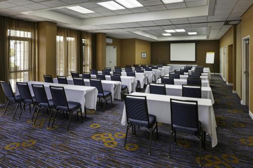 a room with rows of tables and chairs in it at Courtyard by Marriott Riverside UCR/Moreno Valley Area in Riverside
