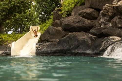 a man riding on a whitelatable at Waikoloa Beach Marriott Resort & Spa in Waikoloa