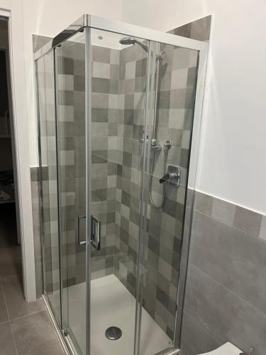 a shower with a glass door in a bathroom at Little House On The Sea in Acireale