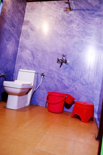 a bathroom with a toilet and a faucet at The Escape Resort in Mussoorie