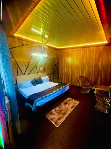 a bedroom with a bed in a wooden room at The Escape Resort in Mussoorie