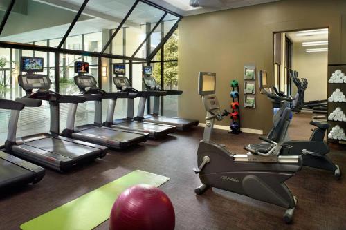 a gym with treadmills and ellipticals in a room at Atlanta Marriott Perimeter Center in Atlanta