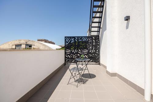 a balcony with a table and chairs on a building at IVY - Boston in Latina