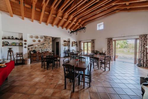 a dining room with tables and chairs in a room at Tenuta Le Tre Rose in Vibonati