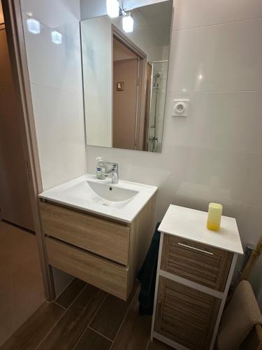 une salle de bain avec un lavabo et un miroir dans l'établissement Appartement grande motte, à La Grande Motte