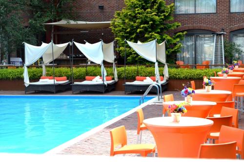 a pool with tables and chairs next to a building at Marriott Providence Downtown in Providence