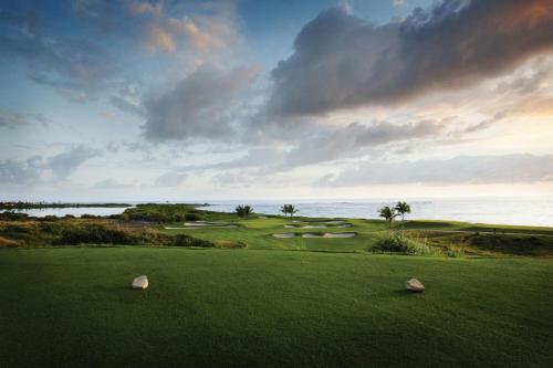 a golf course with a view of the ocean at Marriott St. Kitts Beach Club in Frigate Bay