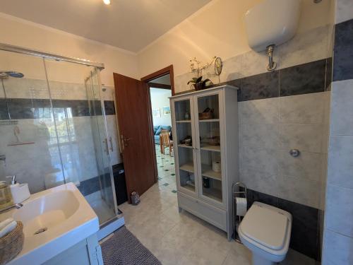 a bathroom with a sink and a toilet and a shower at Orchidea Borghese in Nettuno