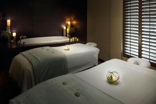 a spa room with two beds and a bath tub at The Westin Hilton Head Island Resort & Spa in Hilton Head Island